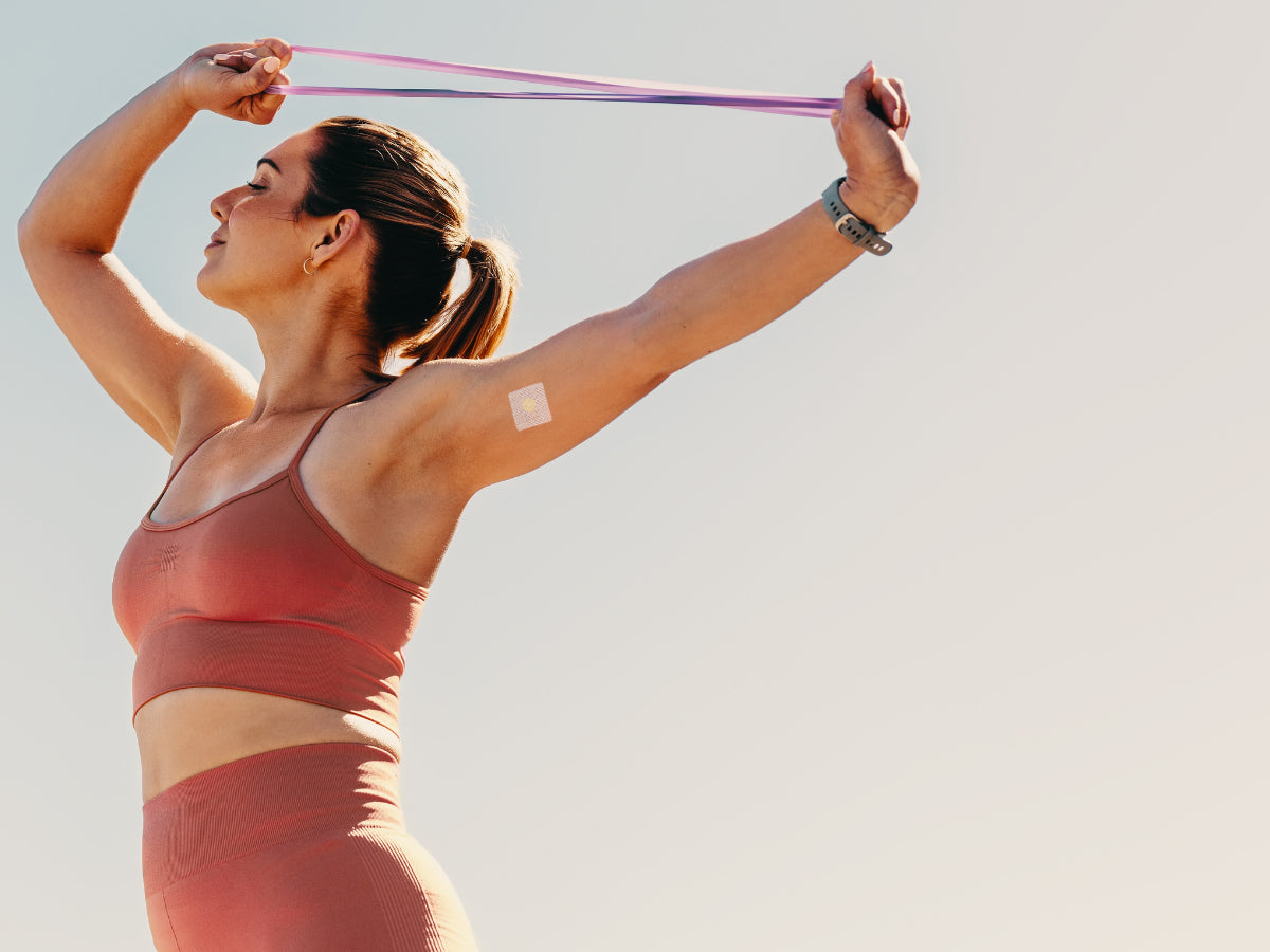 Athletic woman using a B12 patch for energy while training outdoors, demonstrating clean, optimized fueling.