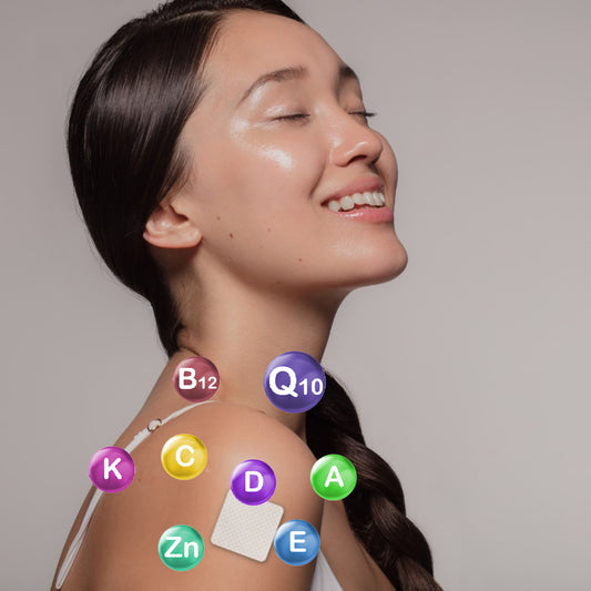 A woman with long, dark hair smiles with her eyes closed, showcasing a vitamin patch on her shoulder surrounded by colorful circles labeled with vitamins and nutrients.