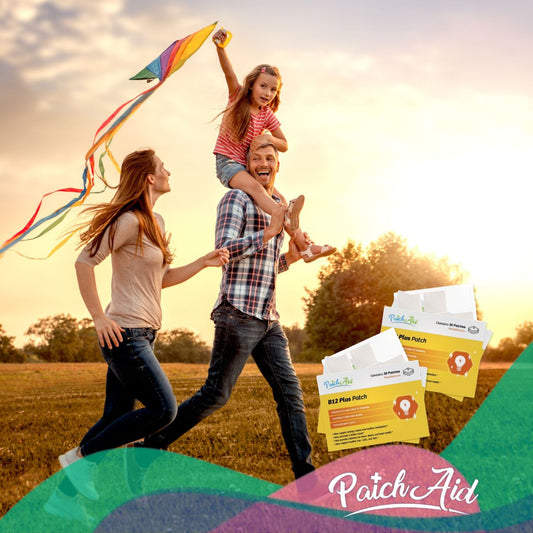 A man joyfully runs with a woman and a girl on his shoulders, while the girl holds a colorful kite, against a sunset backdrop, with Vitamin B12 patches visible in the foreground.