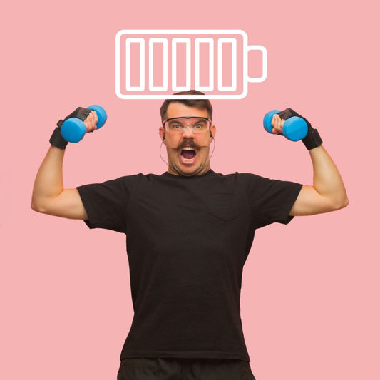 A man with a mustache raises dumbbells above his head, smiling widely, against a pink background with a battery icon above him, symbolizing energy and vitality.
