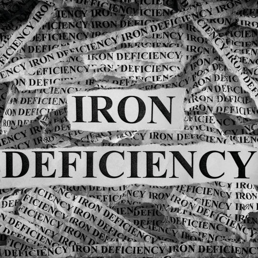 The image features the words "IRON DEFICIENCY" prominently displayed in bold letters on a background of crumpled paper with repeated text, highlighting the topic of iron deficiency symptoms.
