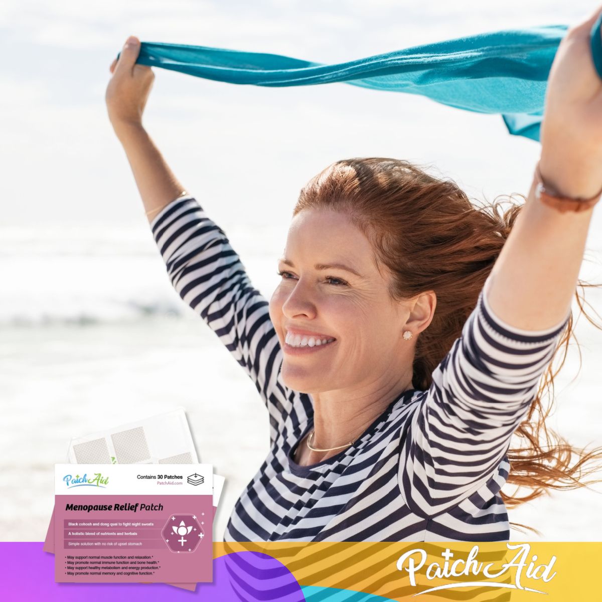 A smiling woman with long, wavy red hair stands on a beach, joyfully lifting a blue scarf in the air, while a menopause relief patch package is visible in the foreground.