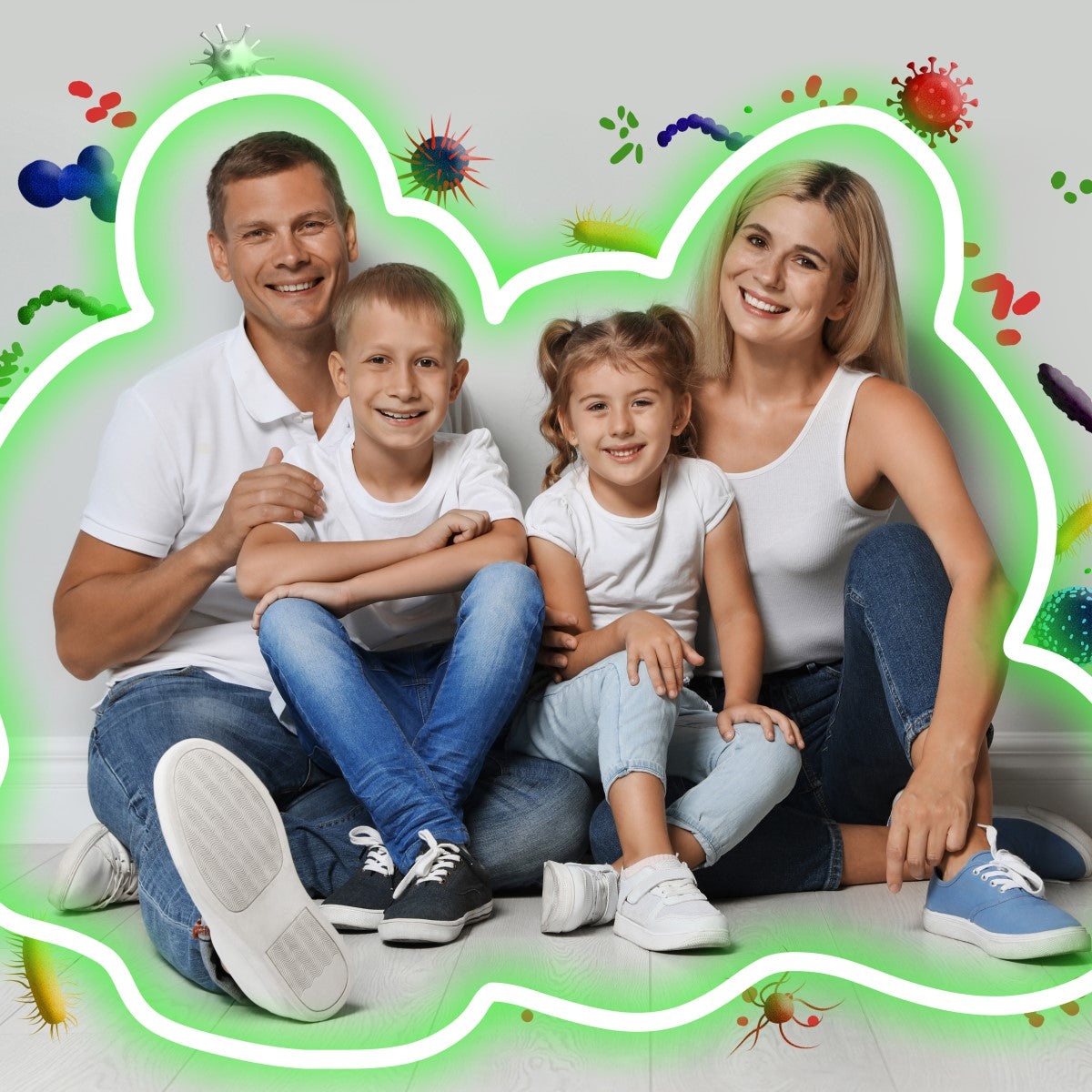 A smiling family of four sits together on the floor, with the parents and two children wearing white shirts, surrounded by colorful illustrations of germs and bacteria, emphasizing the theme of strengthening immunity during flu season.