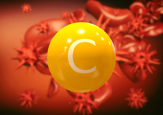 A bright yellow sphere labeled "C" is prominently displayed against a blurred background of red blood cells and immune cells, symbolizing the role of vitamin C in immune support.