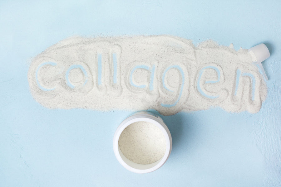 White powder is shaped into the word "collagen" on a light blue surface, with a round container of collagen powder placed nearby, emphasizing its health benefits.