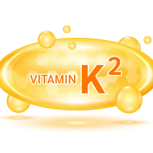 A bright yellow oval graphic features the text "VITAMIN K2" in orange, surrounded by bubbles, set against a honeycomb background, highlighting the benefits of Vitamin K2.