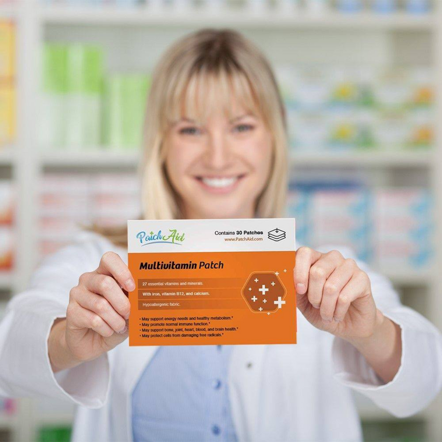 A smiling woman in a lab coat holds up a multivitamin patch package in a pharmacy setting, showcasing its benefits and ingredients against a blurred background of shelves.