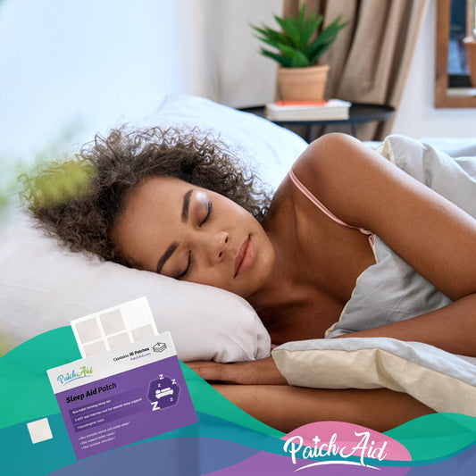 A woman with curly hair sleeps peacefully on a pillow in a cozy bedroom, with a Sleep Aid Patch package visible on the bed, highlighting the importance of quality sleep.