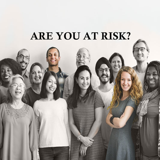 A diverse group of smiling people stands together, with a prominent text overlay asking, "ARE YOU AT RISK?" suggesting a focus on vitamin deficiency awareness.