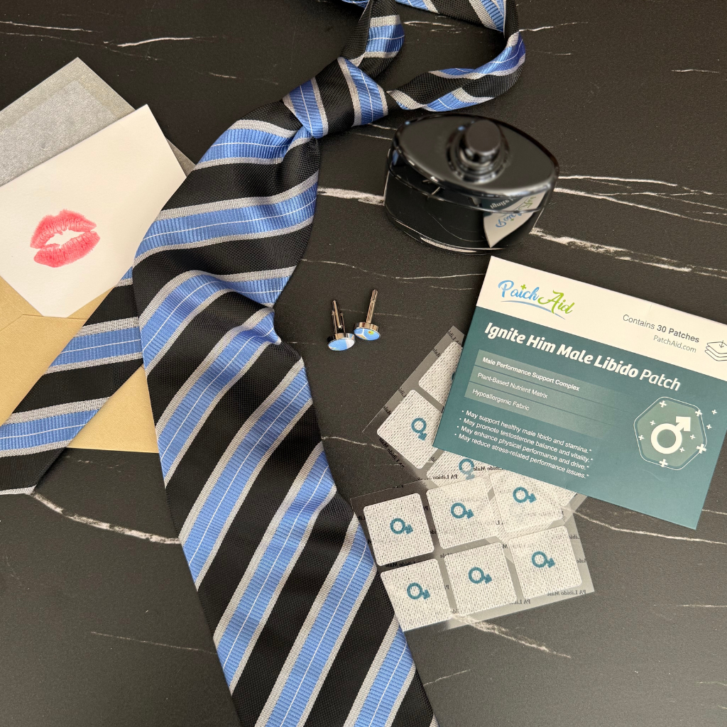 Striped tie, libido patch packaging, and small items on a dark surface