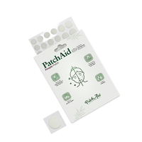 A package of PatchAid Pimple Patches is displayed, featuring a clear window showing round patches, with illustrations and text highlighting benefits for skin care.